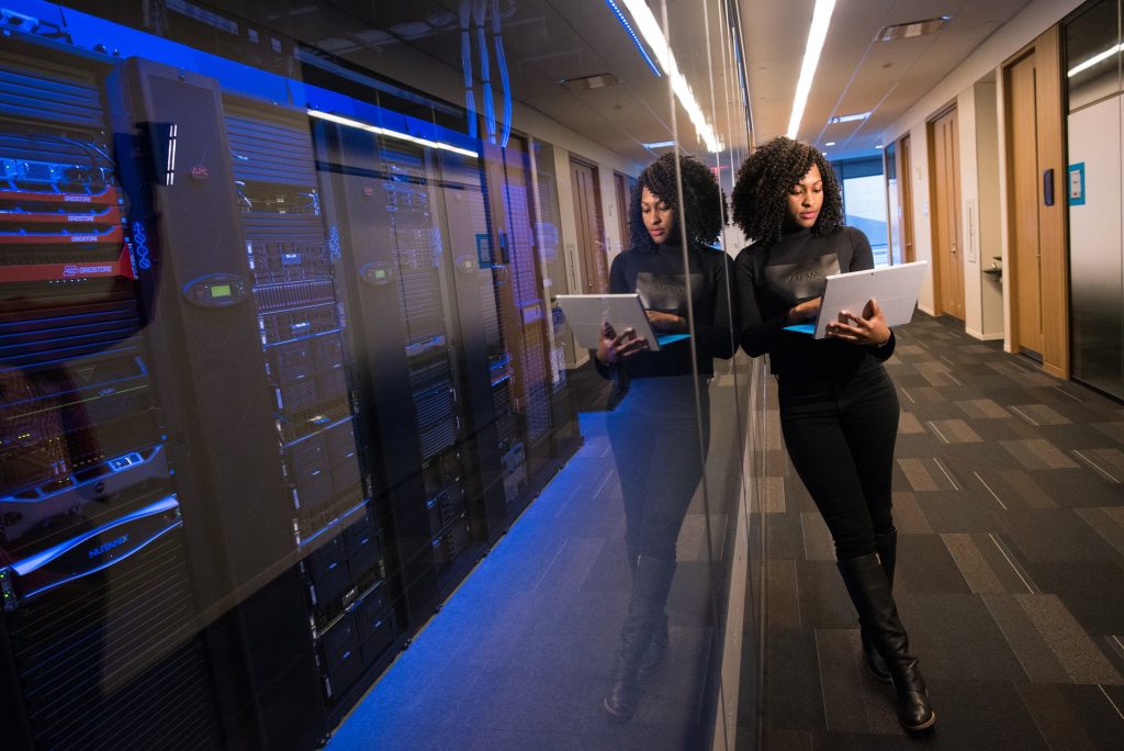 Woman standing in room with computer